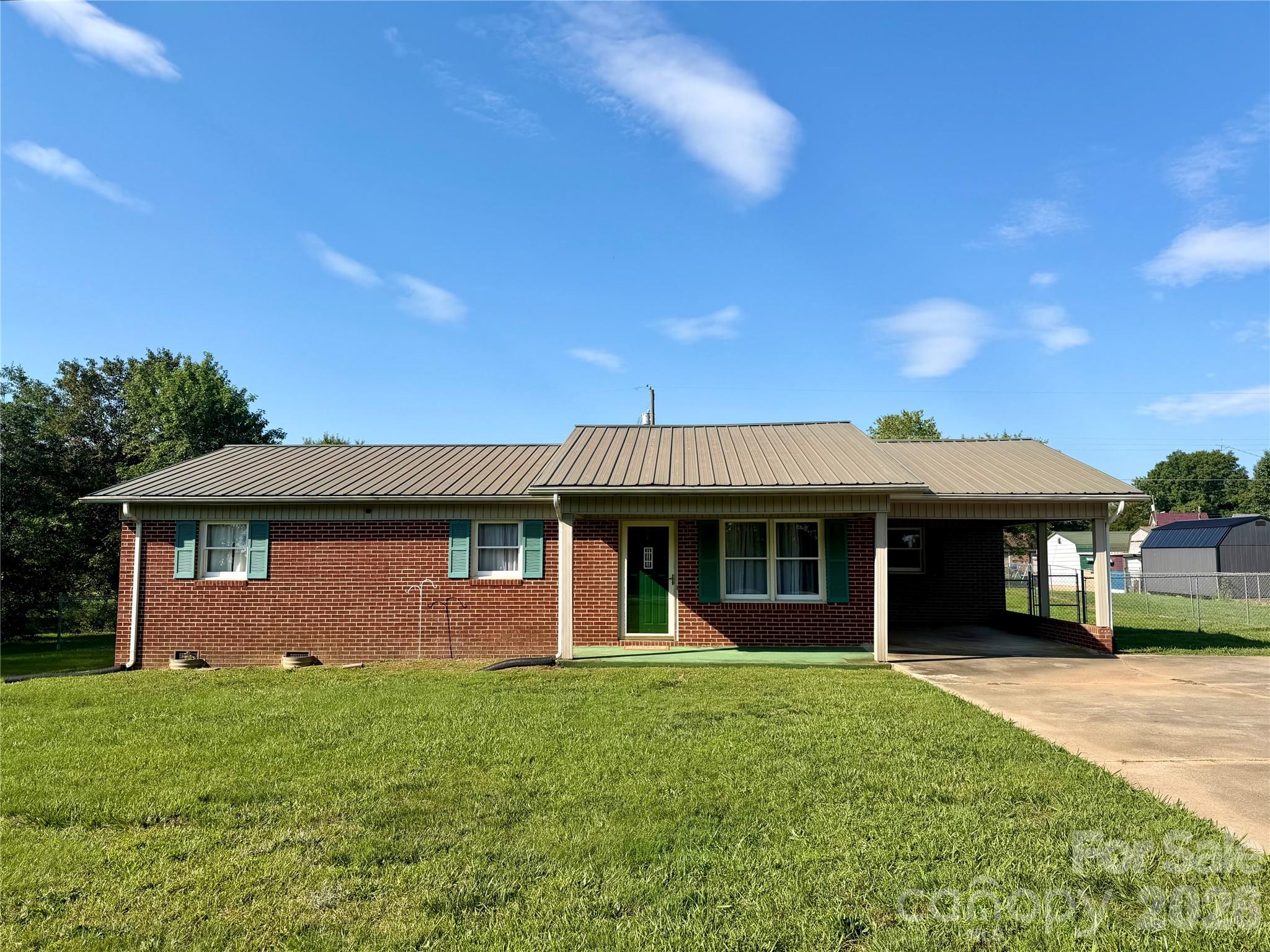 372 Ferry Road Forest City, NC 28043 - Photo 1 of 36 a front view of a house with a garden