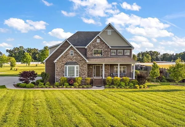 a front view of house with yard and green space