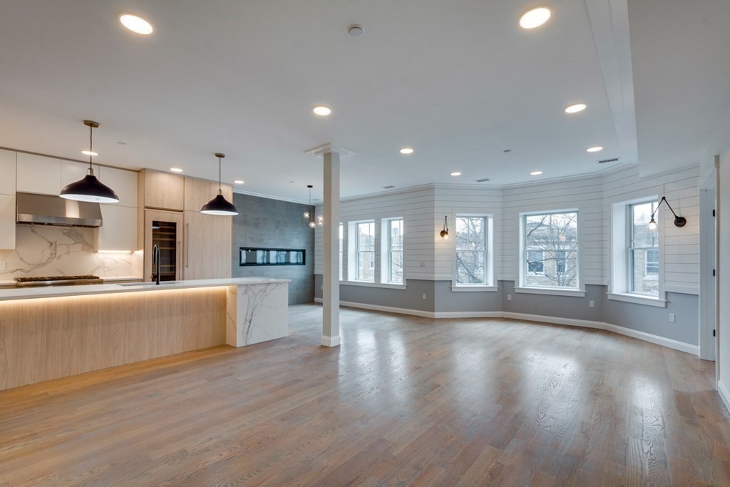15 Euston Street, Unit 3 Brookline, MA 02446 - Photo 12 of 37 a open kitchen with stainless steel appliances granite countertop a large counter top a stove and a wooden floors
