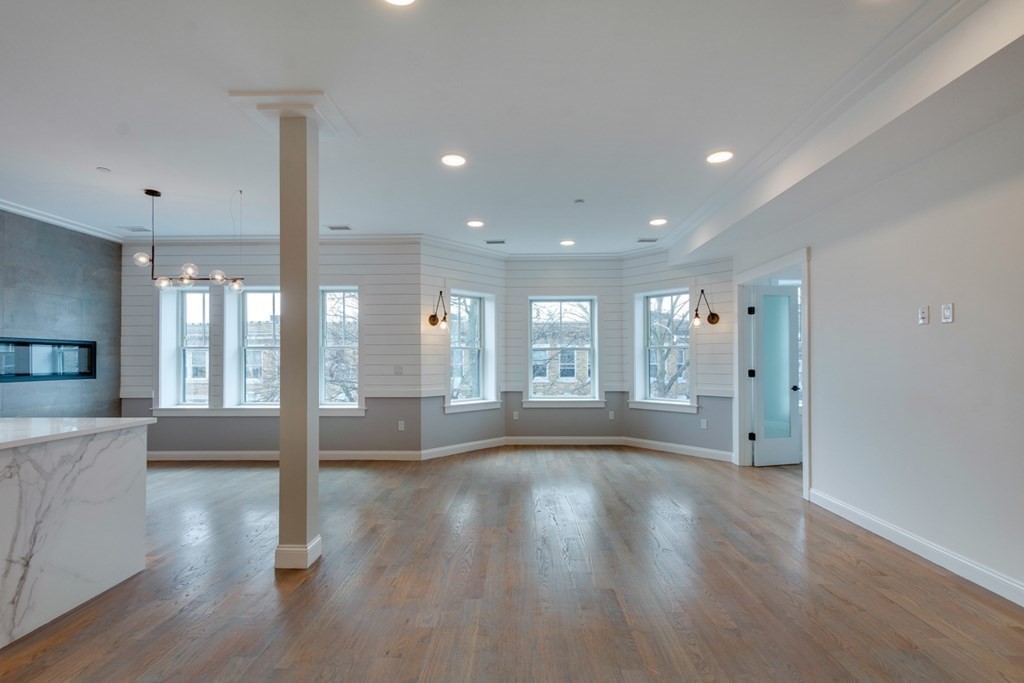 15 Euston Street, Unit 3 Brookline, MA 02446 - Photo 13 of 37 a view of an empty room with wooden floor and a window