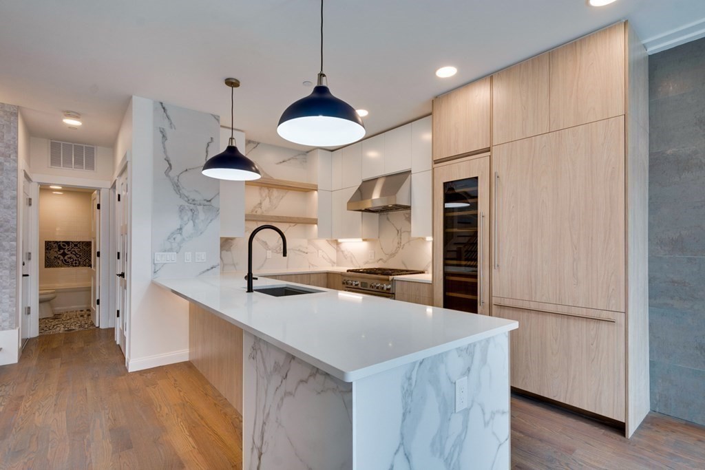 15 Euston Street, Unit 3 Brookline, MA 02446 - Photo 16 of 37 a kitchen with stainless steel appliances a sink and a refrigerator
