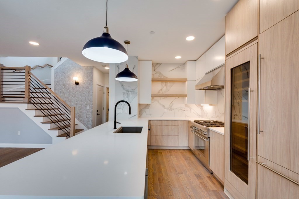 15 Euston Street, Unit 3 Brookline, MA 02446 - Photo 17 of 37 a kitchen with stainless steel appliances granite countertop a sink a stove and a refrigerator