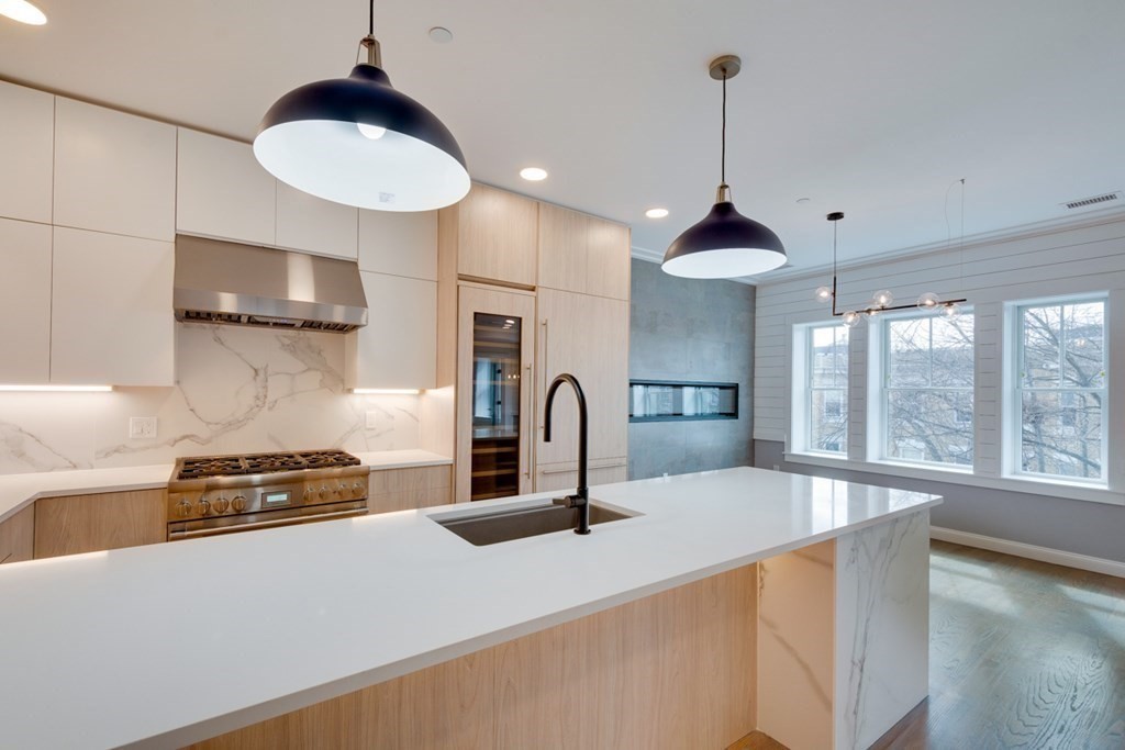 15 Euston Street, Unit 3 Brookline, MA 02446 - Photo 18 of 37 a kitchen with stainless steel appliances granite countertop a stove a sink and a refrigerator