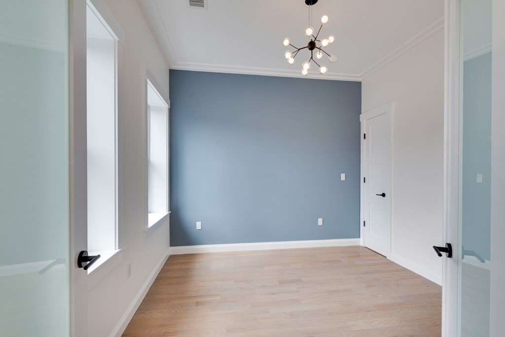15 Euston Street, Unit 3 Brookline, MA 02446 - Photo 19 of 37 wooden floor in an empty room with a window