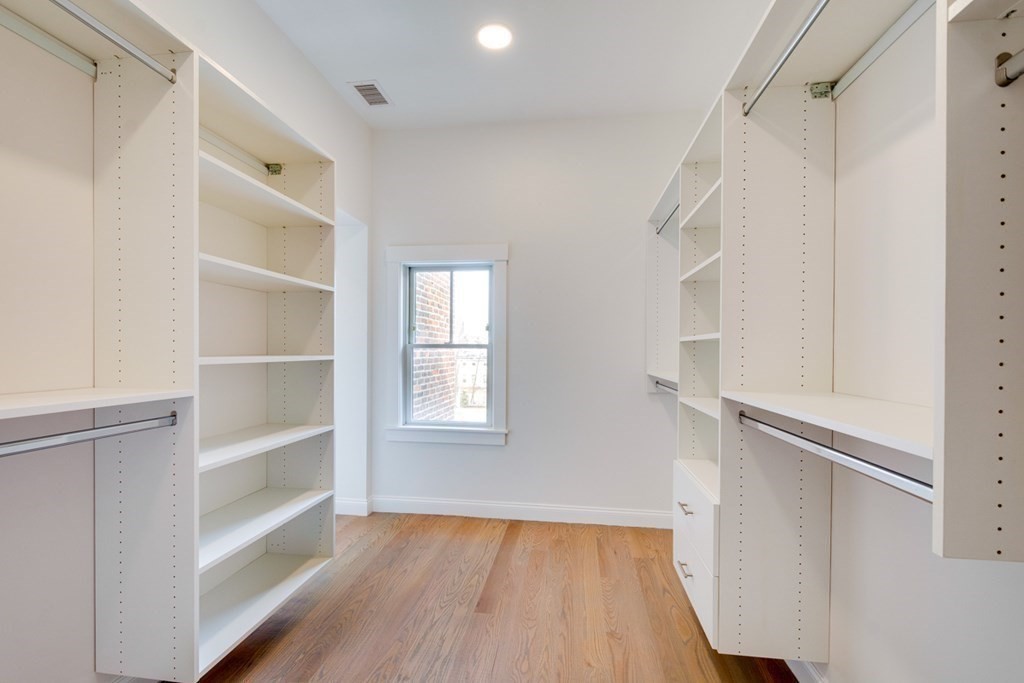 15 Euston Street, Unit 3 Brookline, MA 02446 - Photo 26 of 37 a view of an empty walk in closet with wooden floor