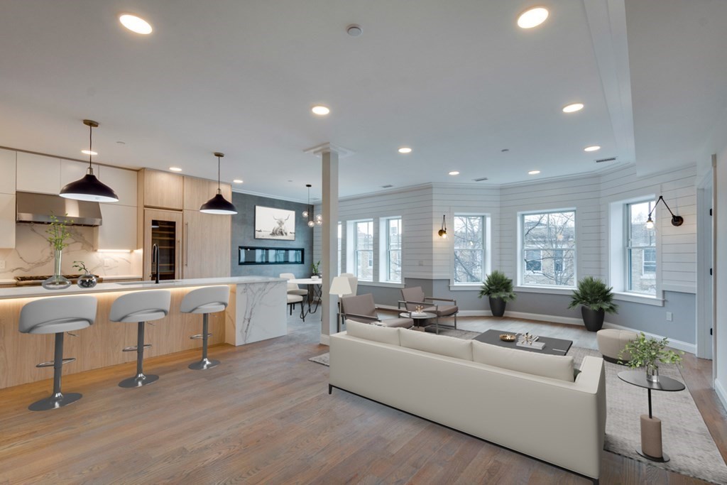15 Euston Street, Unit 3 Brookline, MA 02446 - Photo 6 of 37 a living room with furniture kitchen area and a wooden floor