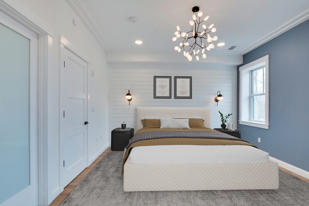 15 Euston Street, Unit 3 Brookline, MA 02446 - Photo 8 of 37 a bedroom with a large bed chandelier and a window