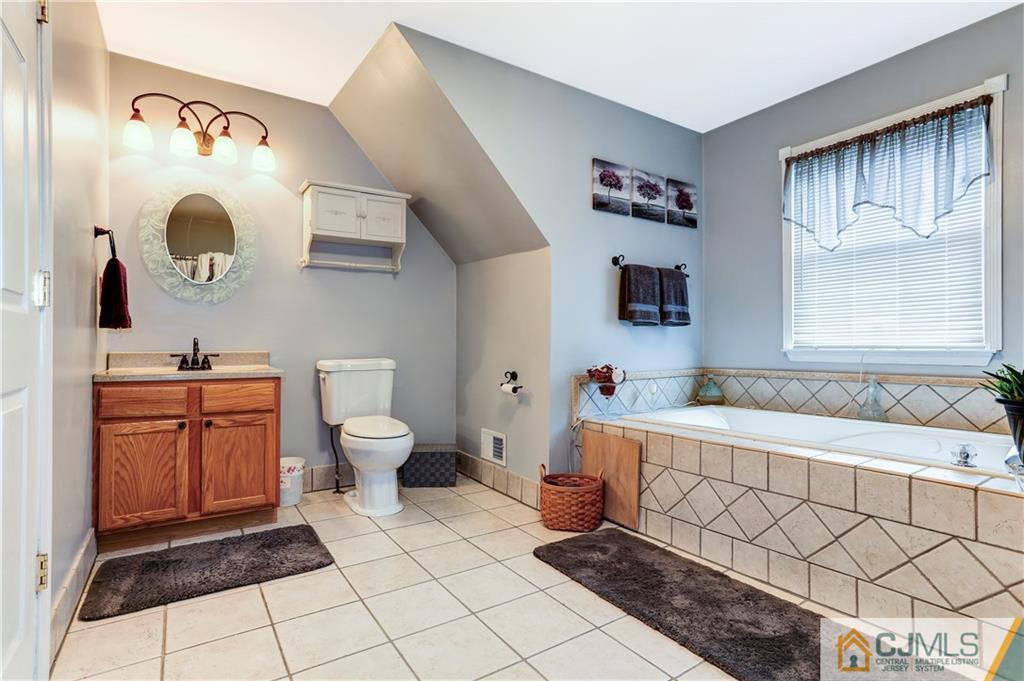 7 Country Road Jackson, NJ 08527 - Photo 23 of 44 a spacious bathroom with a bathtub sink and toilet