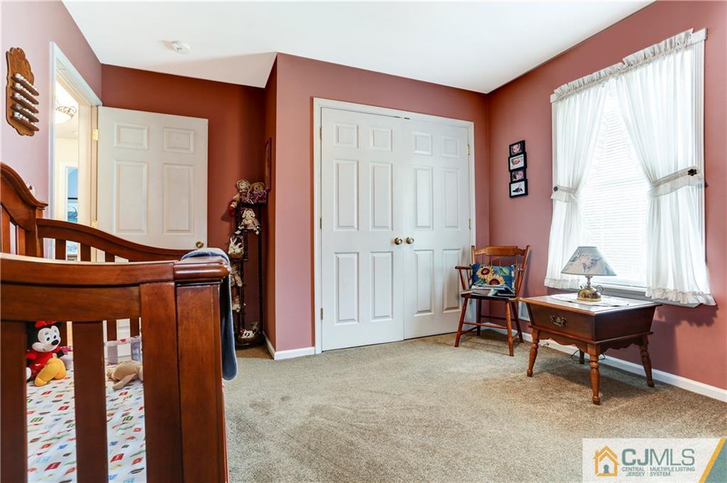 7 Country Road Jackson, NJ 08527 - Photo 29 of 44 a living room with furniture a window and a potted plant