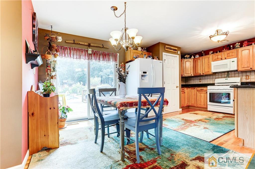 7 Country Road Jackson, NJ 08527 - Photo 5 of 44 a dining room filled with furniture and a chandelier