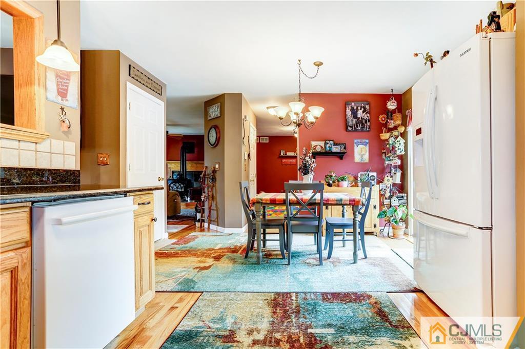7 Country Road Jackson, NJ 08527 - Photo 6 of 44 a view of a dining room with furniture a chandelier and wooden floor