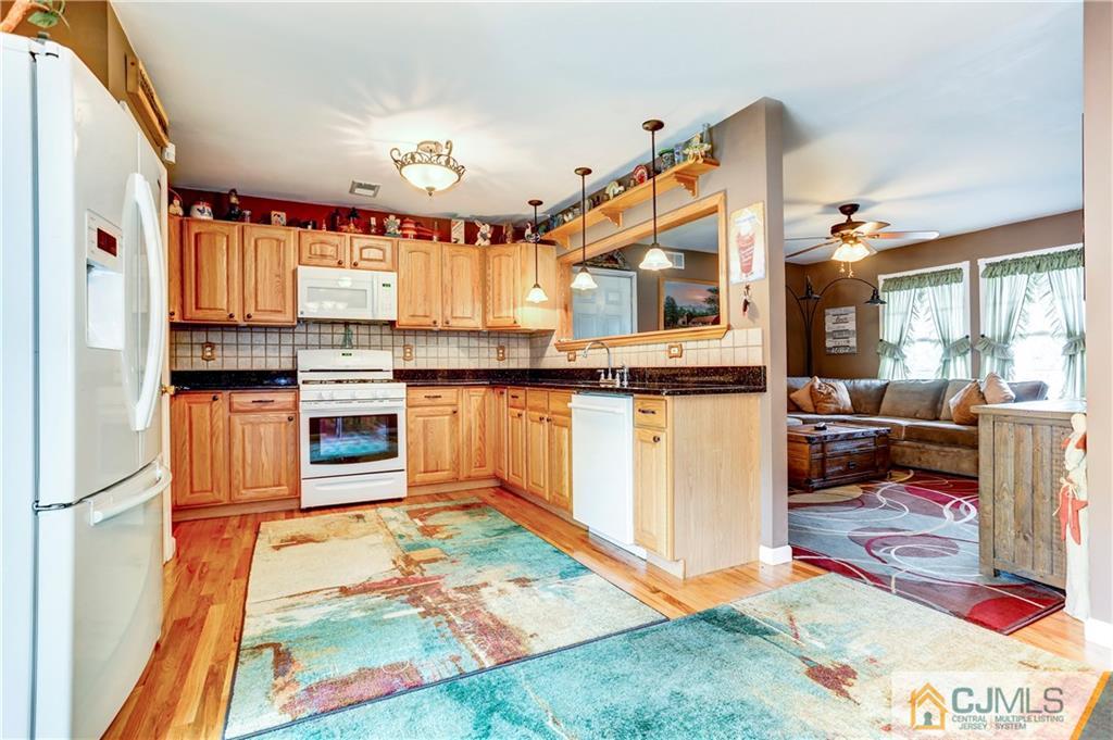 7 Country Road Jackson, NJ 08527 - Photo 8 of 44 a kitchen with stainless steel appliances granite countertop a stove a sink and a refrigerator