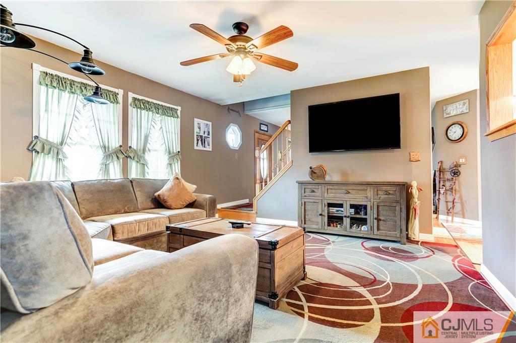 7 Country Road Jackson, NJ 08527 - Photo 10 of 44 a living room with fireplace furniture and a flat screen tv