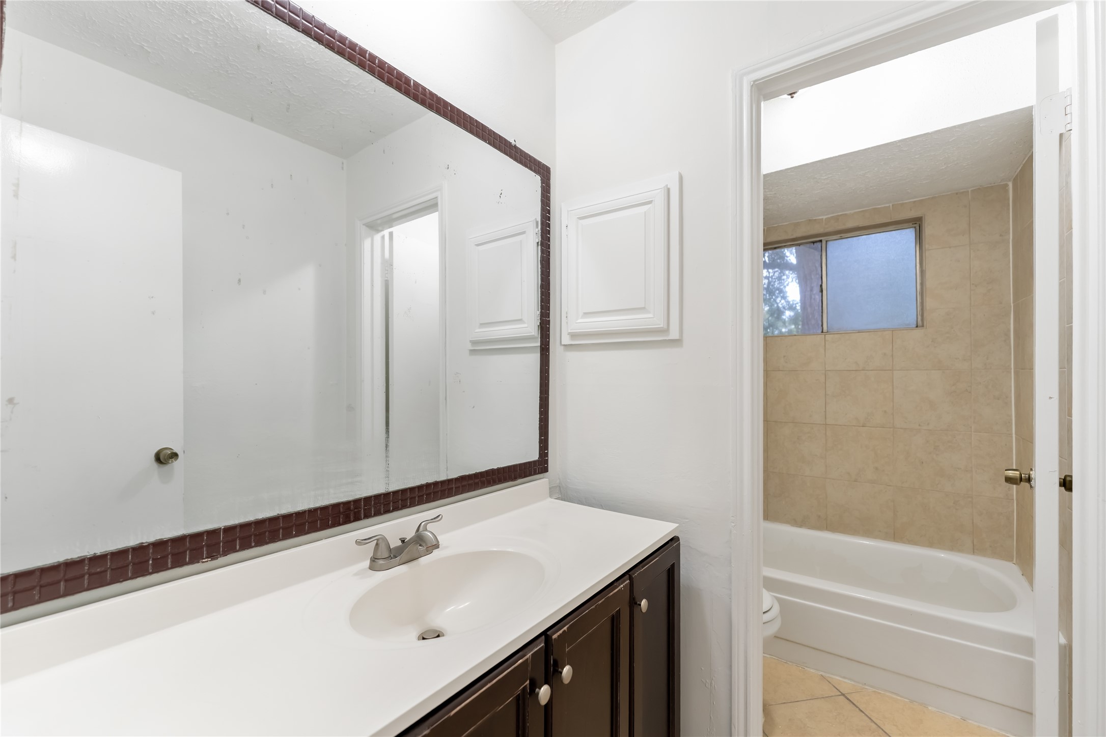 4927 Glendower Drive Spring, TX 77373 - Photo 18 of 22 a bathroom with a sink and a mirror