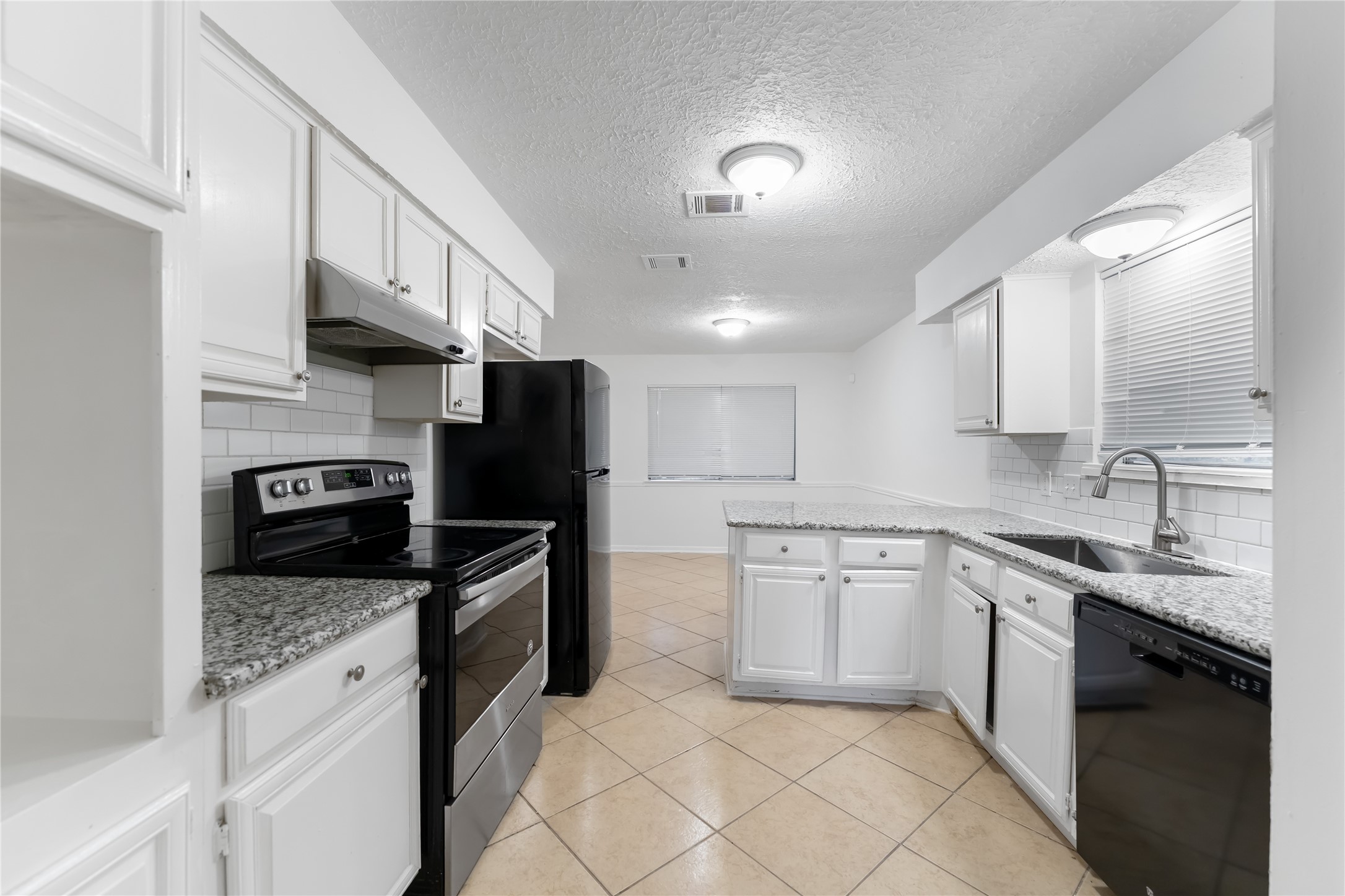 4927 Glendower Drive Spring, TX 77373 - Photo 3 of 22 a kitchen with stainless steel appliances granite countertop a stove sink and cabinets