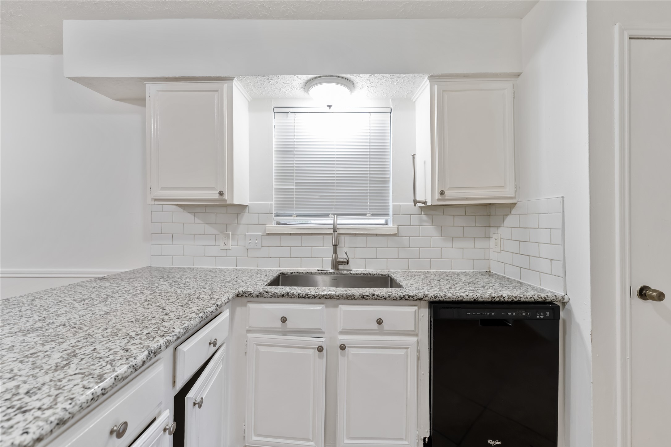 4927 Glendower Drive Spring, TX 77373 - Photo 4 of 22 a kitchen with granite countertop white cabinets and a sink