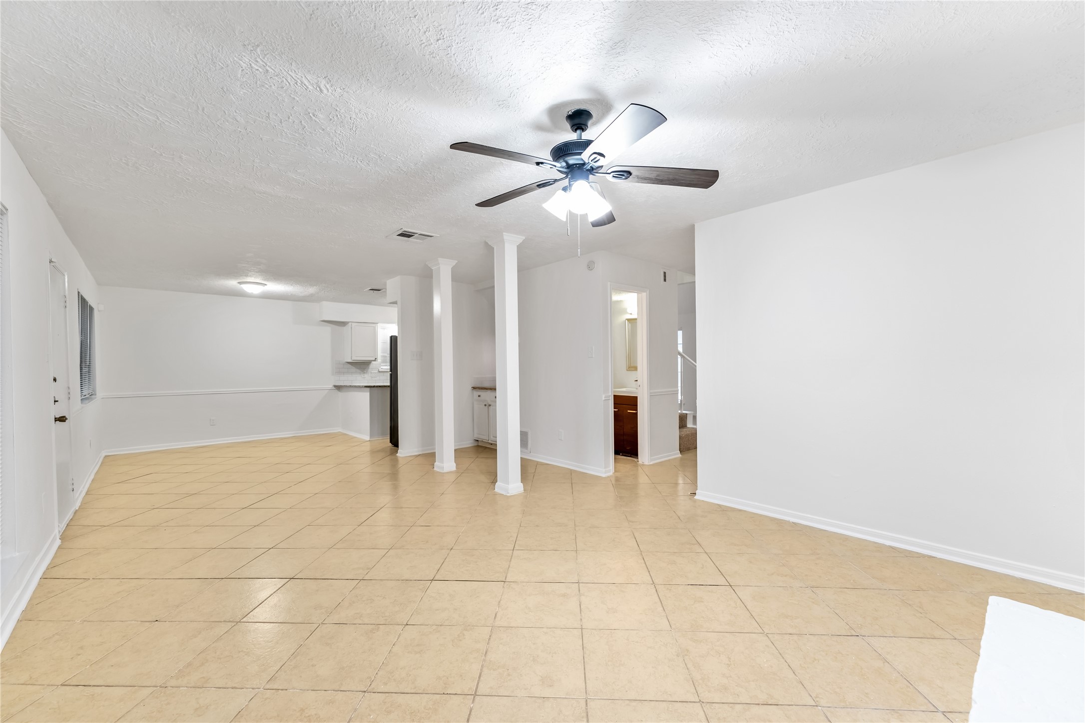 4927 Glendower Drive Spring, TX 77373 - Photo 8 of 22 a view of a livingroom with a ceiling fan and kitchen space