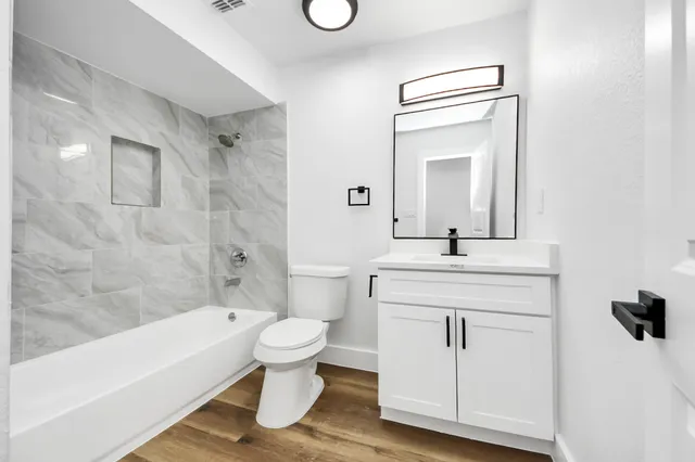 a bathroom with a sink a toilet and a bathtub