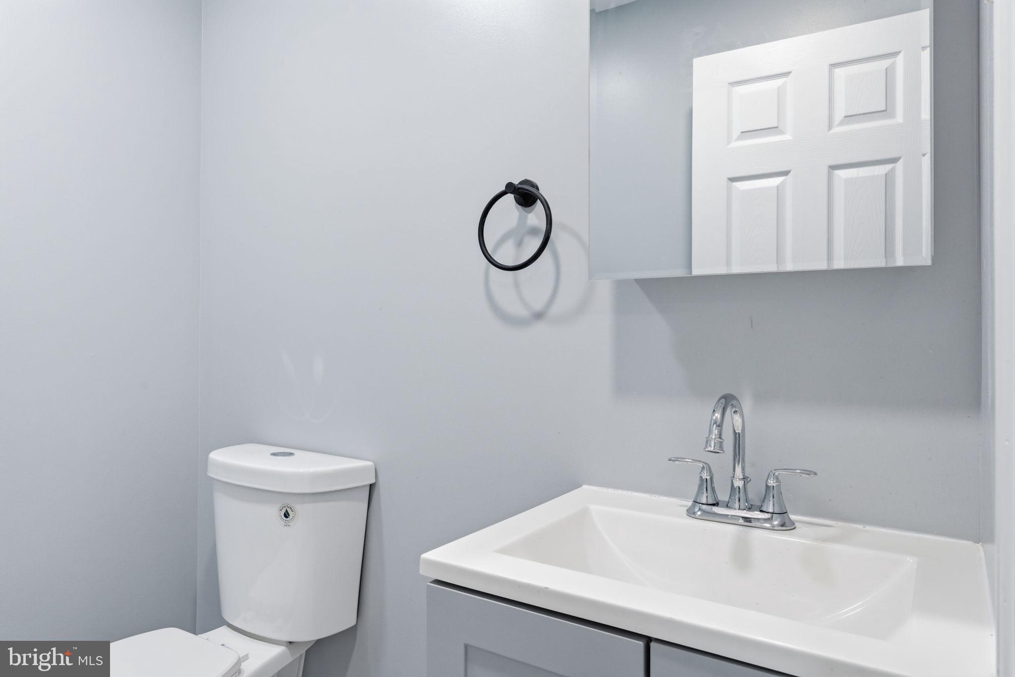 3128 F Street Philadelphia, PA 19134 - Photo 9 of 30 a bathroom with a toilet sink and mirror