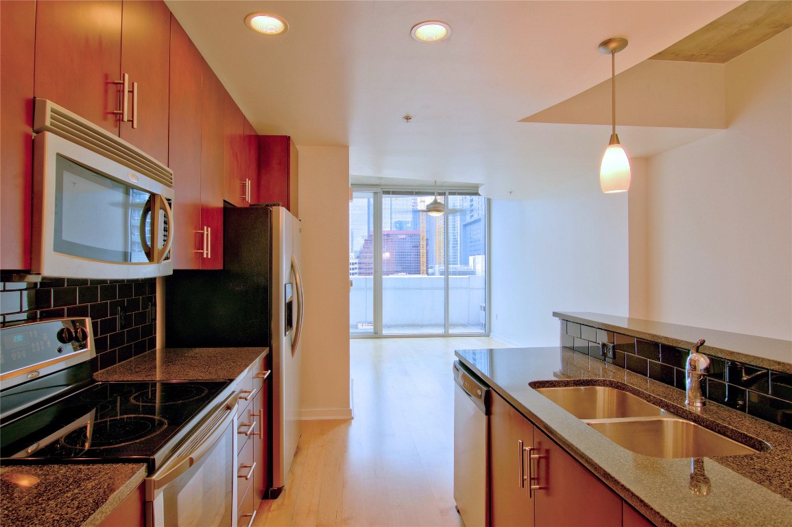 360 Nueces Street, Unit 913 Austin, TX 78701 - Photo 4 of 30 a kitchen that has a sink a counter space and cabinets