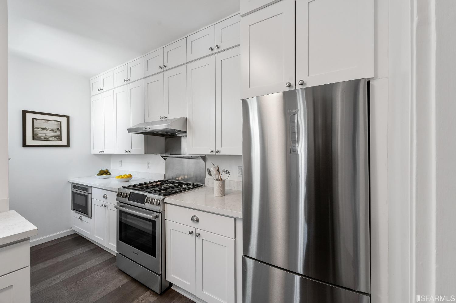 439-441 11th Avenue San Francisco, CA 94118 - Photo 16 of 73 a kitchen with stainless steel appliances a refrigerator stove and white cabinets