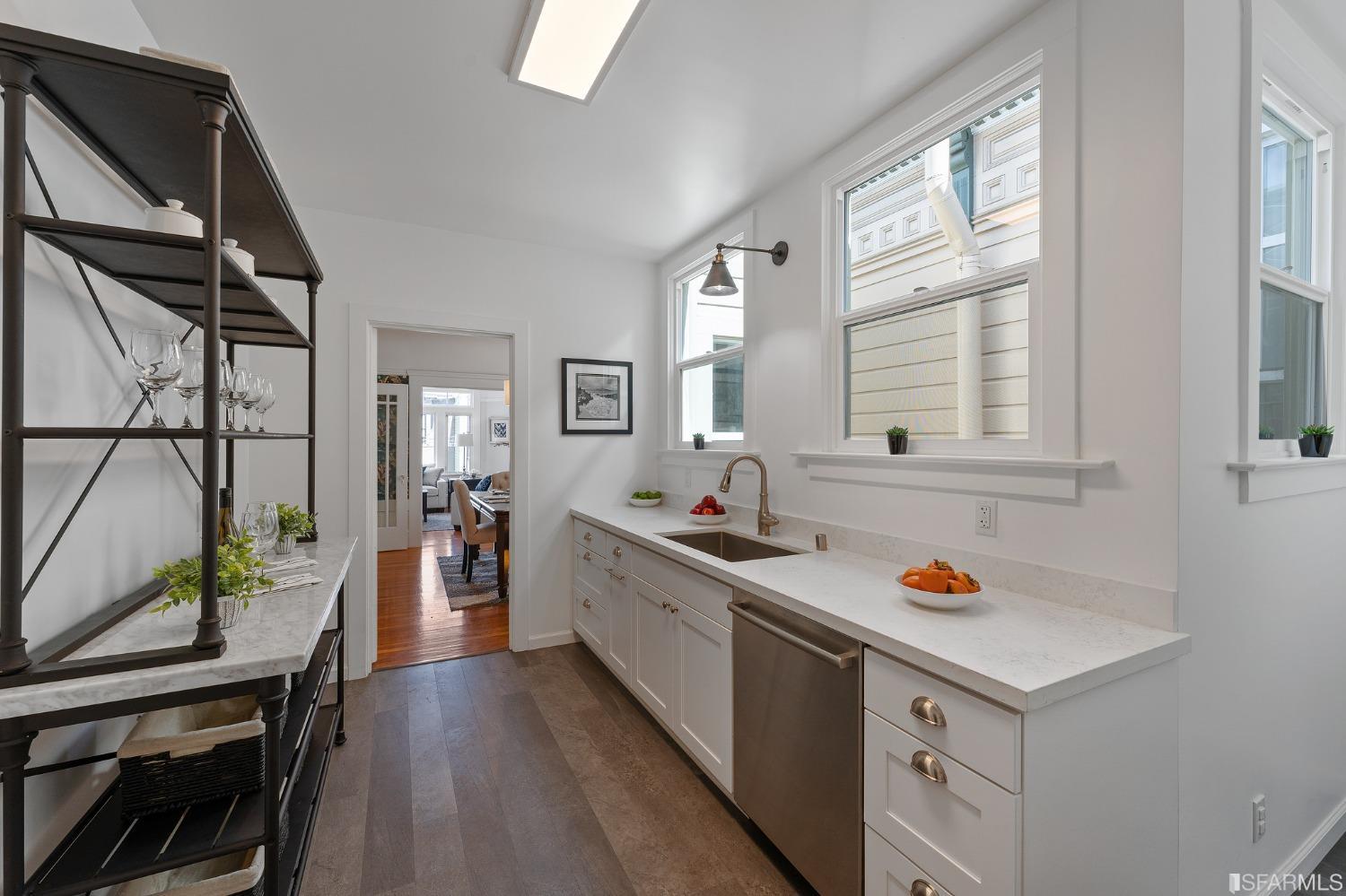 439-441 11th Avenue San Francisco, CA 94118 - Photo 18 of 73 a kitchen that has a lot of cabinets a sink and a stove in it