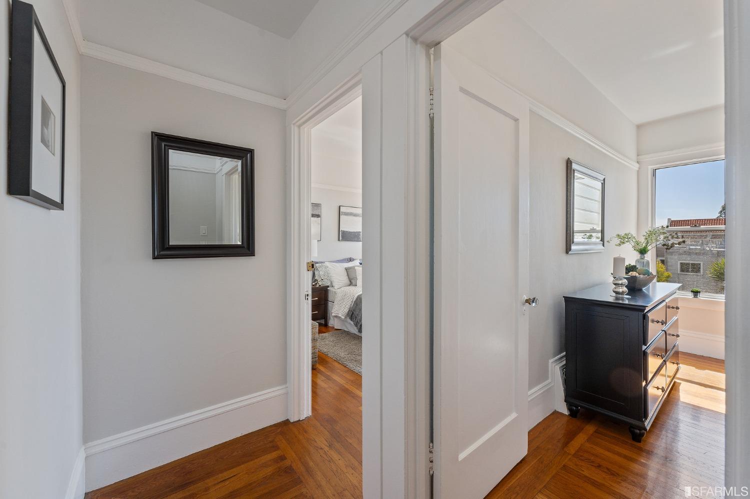 439-441 11th Avenue San Francisco, CA 94118 - Photo 20 of 73 a view of a hallway with wooden floor and a bedroom