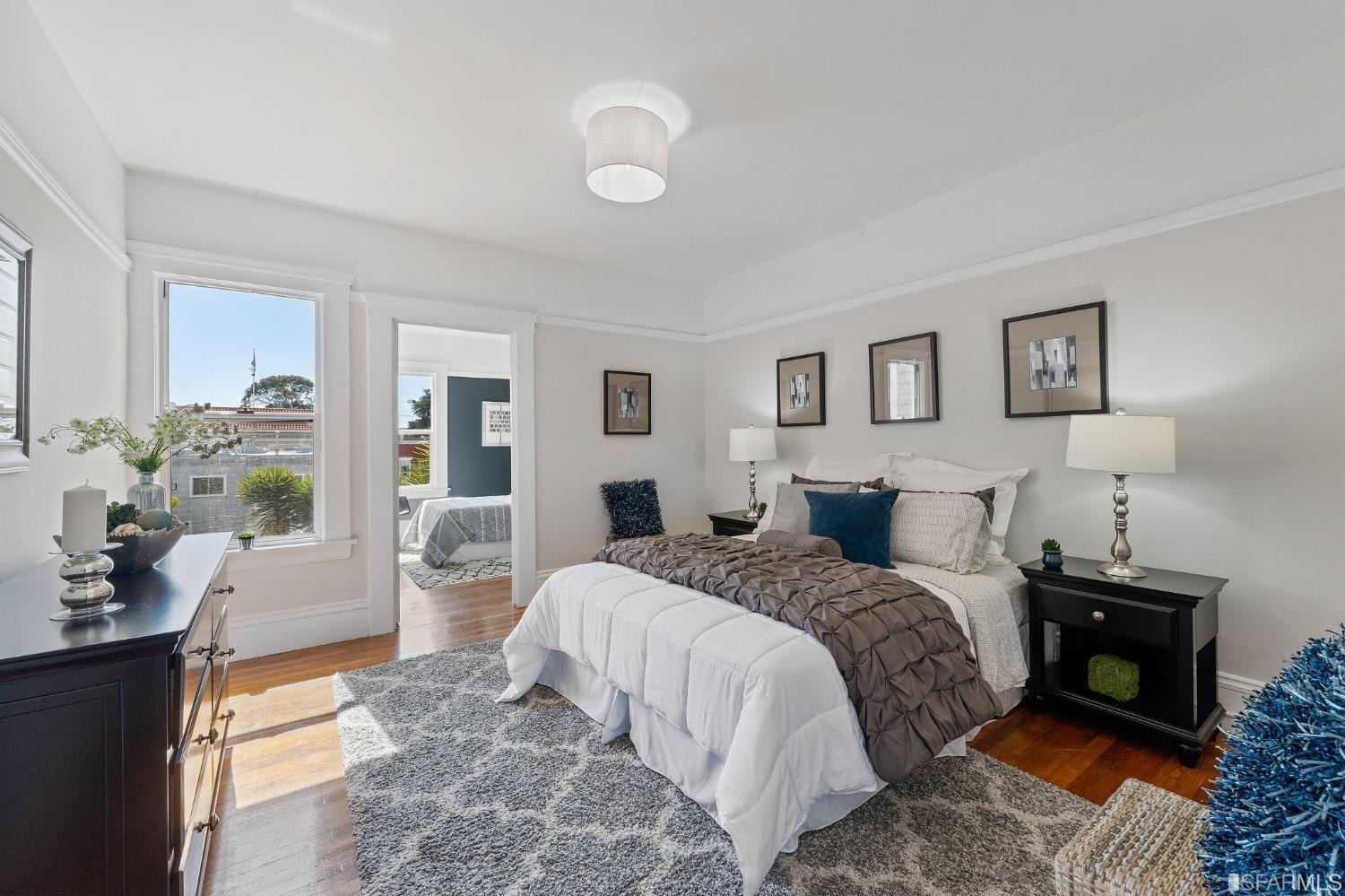 439-441 11th Avenue San Francisco, CA 94118 - Photo 25 of 73 a bedroom with a bed and wooden floor