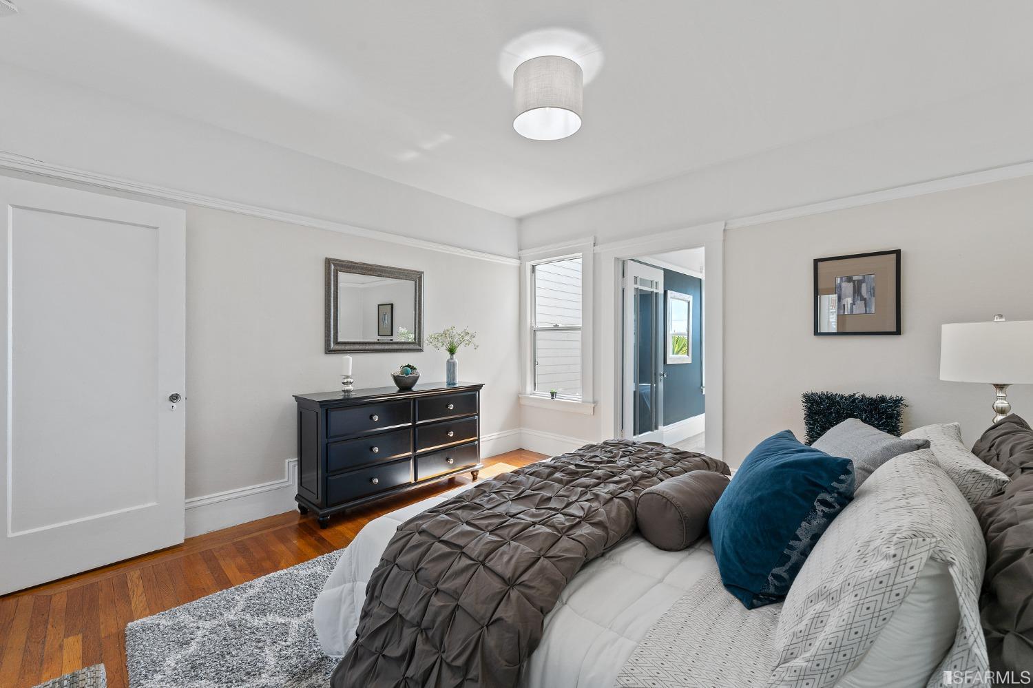 439-441 11th Avenue San Francisco, CA 94118 - Photo 26 of 73 a bedroom with a bed and wooden floor