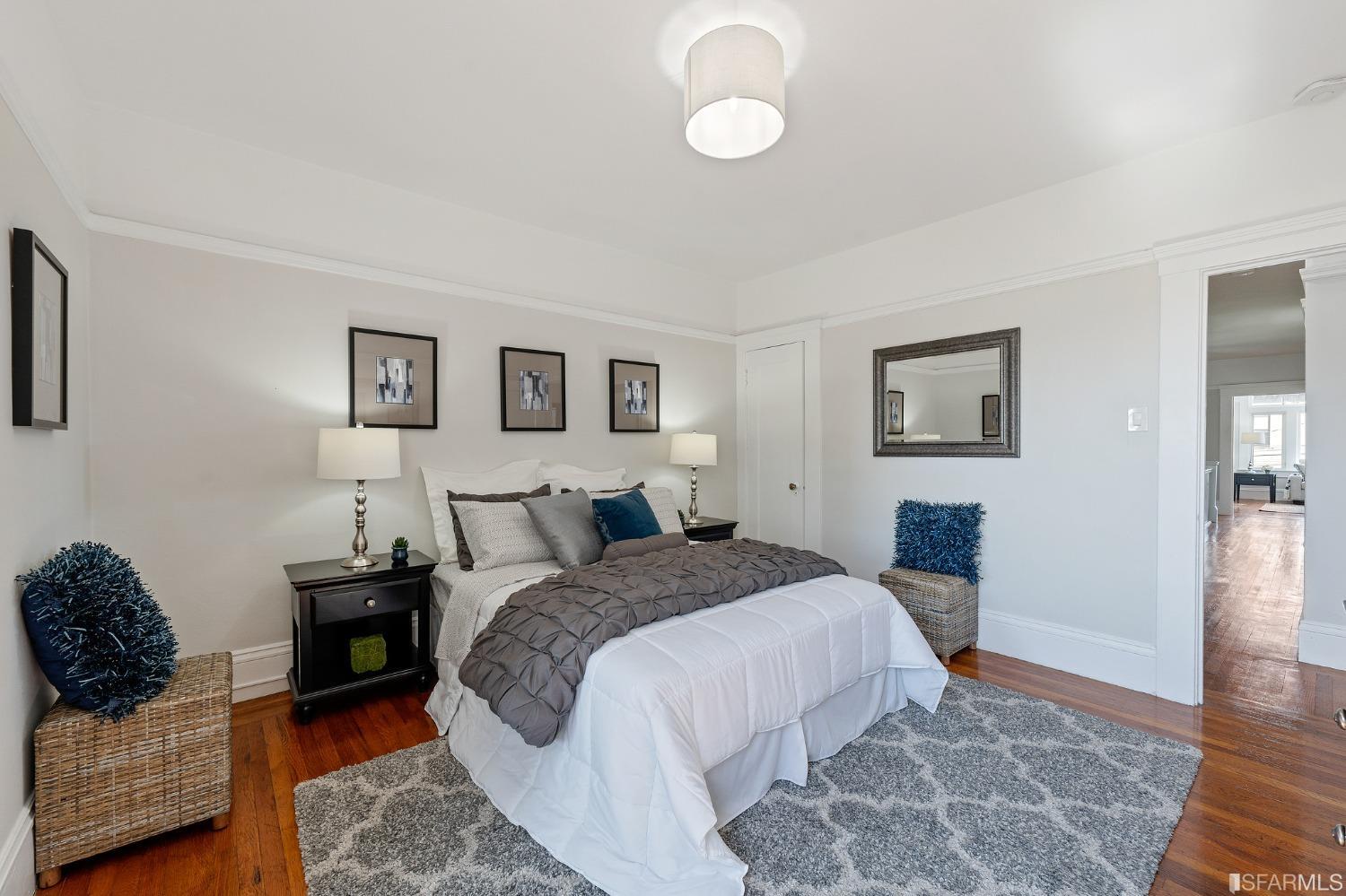 439-441 11th Avenue San Francisco, CA 94118 - Photo 27 of 73 a bed room with a bed a couch and painting on the wall