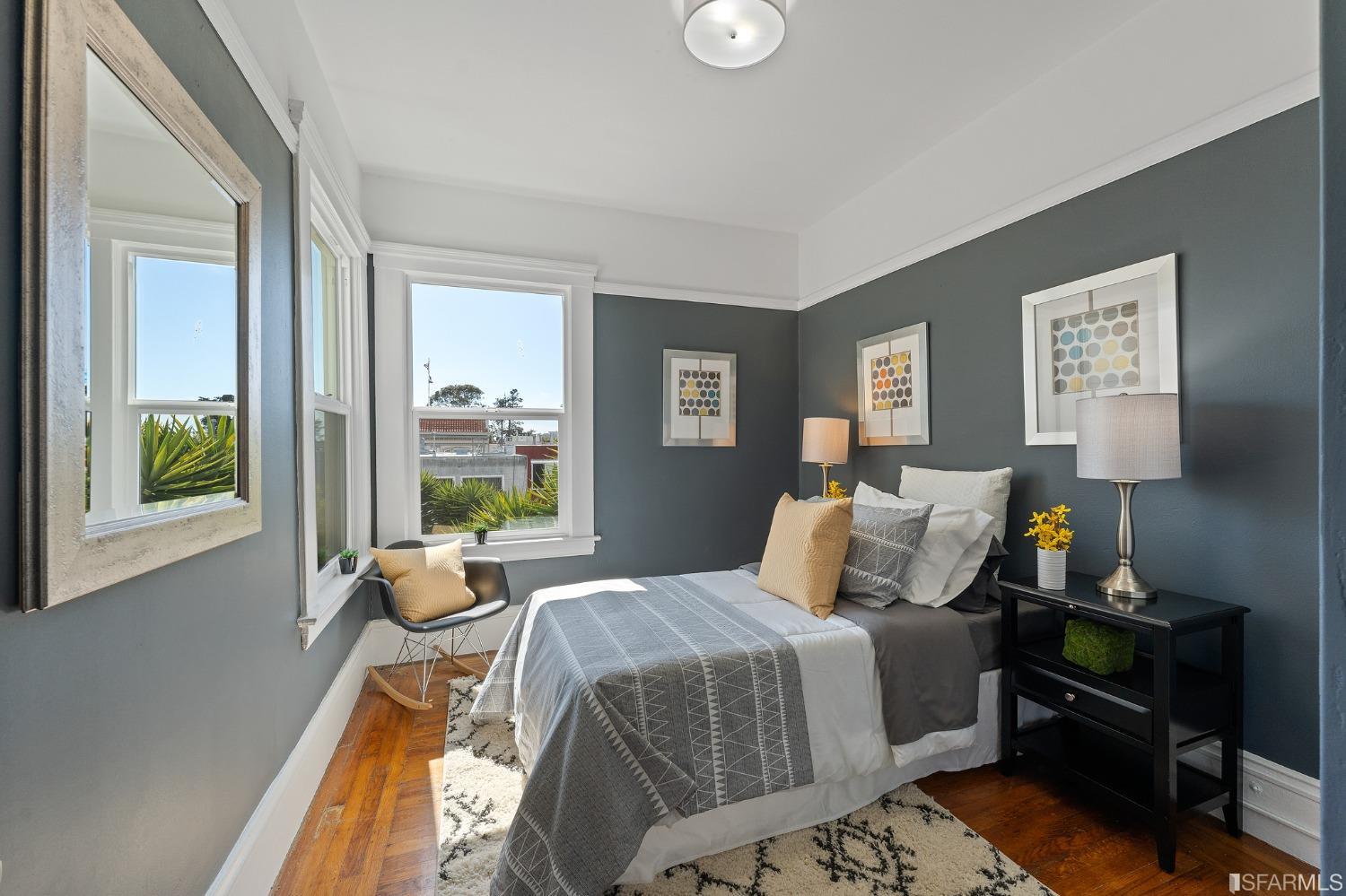 439-441 11th Avenue San Francisco, CA 94118 - Photo 28 of 73 a bedroom with a bed and wooden floor