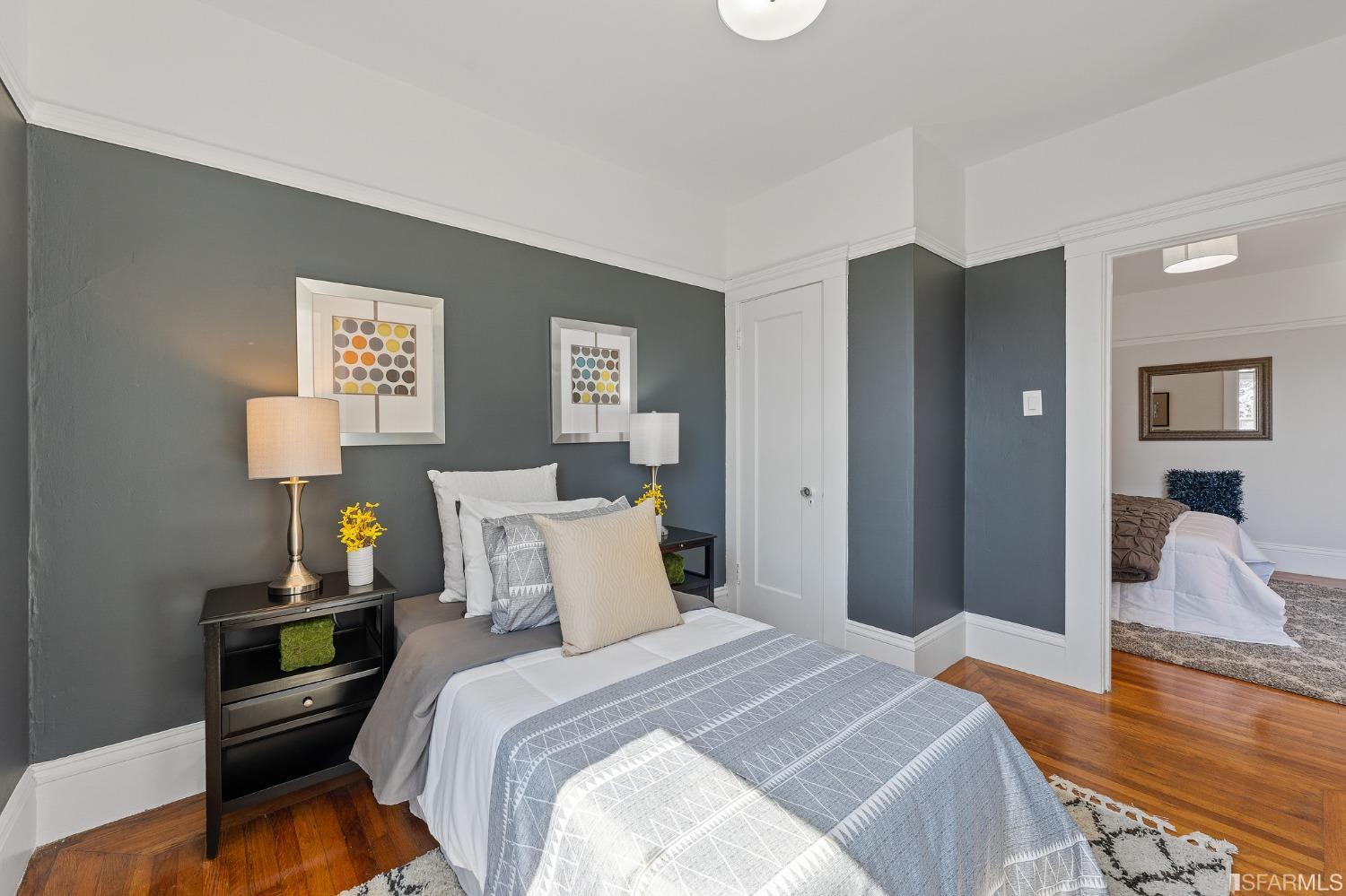 439-441 11th Avenue San Francisco, CA 94118 - Photo 30 of 73 a bedroom with bed and wooden floor