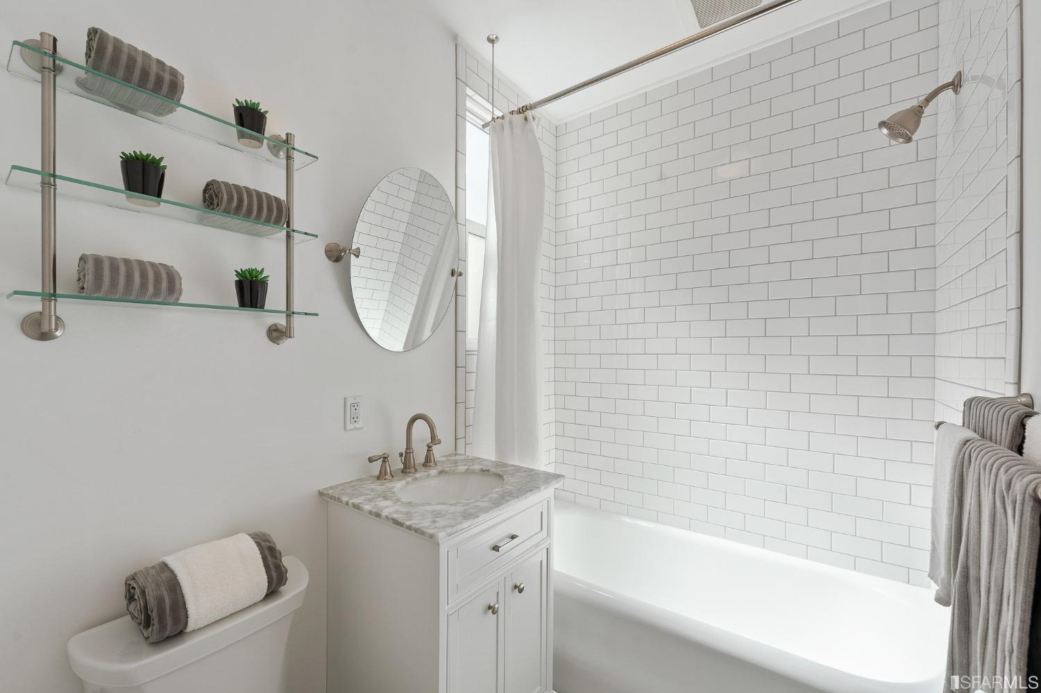 439-441 11th Avenue San Francisco, CA 94118 - Photo 32 of 73 a bathroom with a granite countertop sink and a mirror