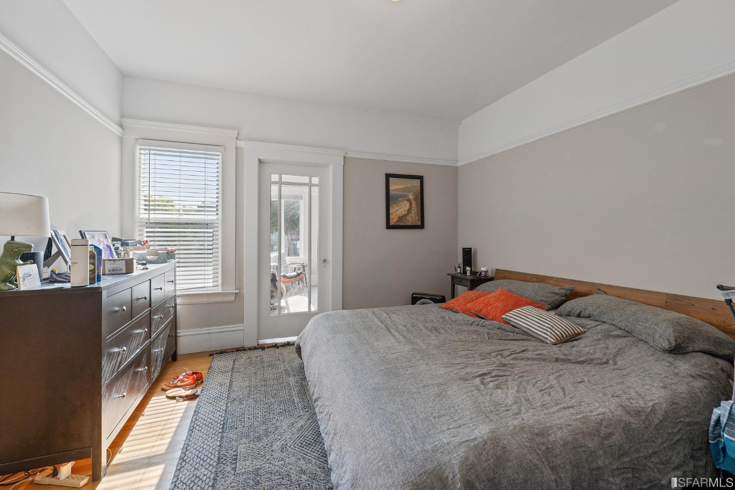 439-441 11th Avenue San Francisco, CA 94118 - Photo 46 of 73 a bedroom with a bed and wooden floor