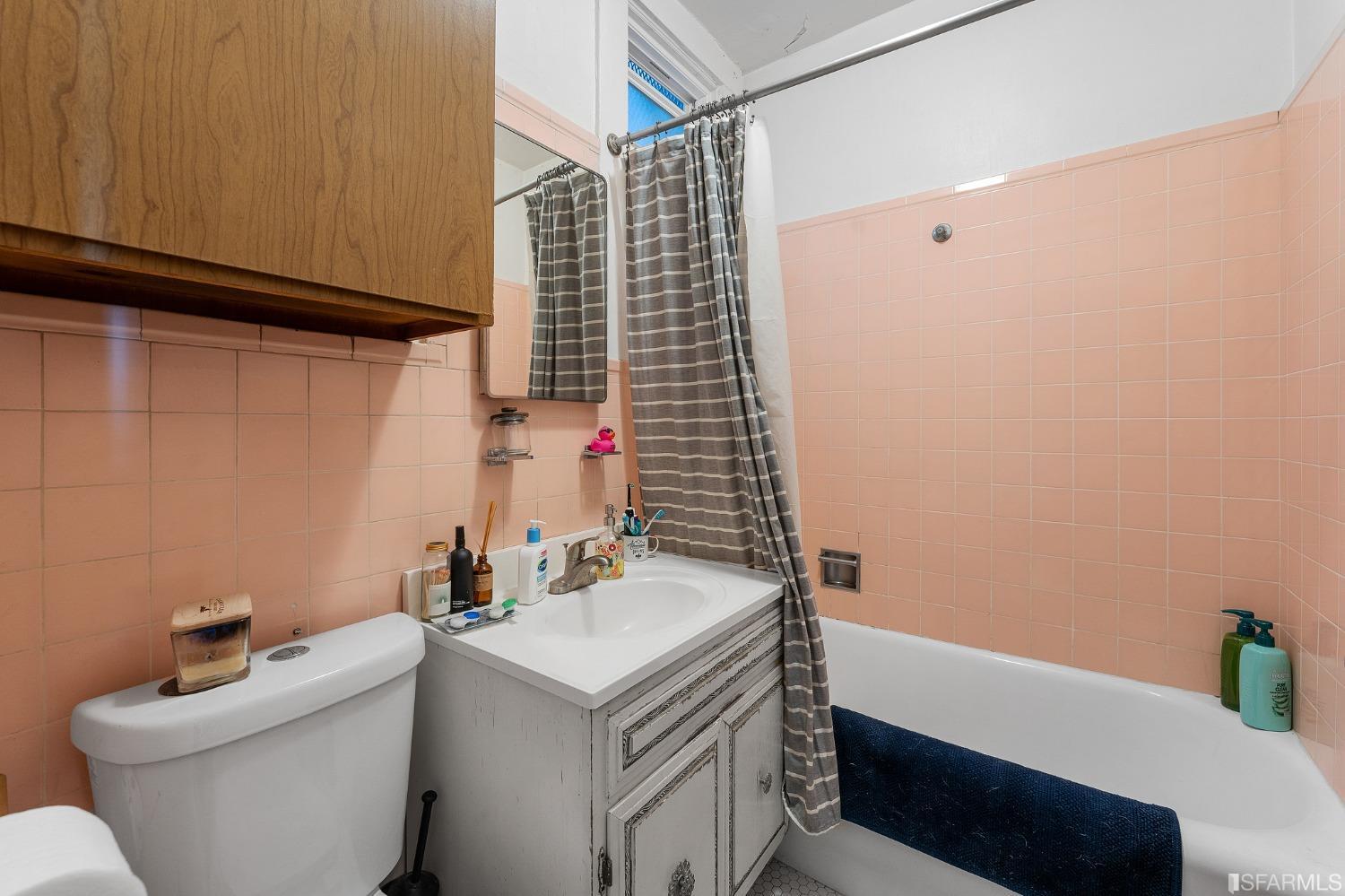 439-441 11th Avenue San Francisco, CA 94118 - Photo 48 of 73 a bathroom with a sink and a mirror