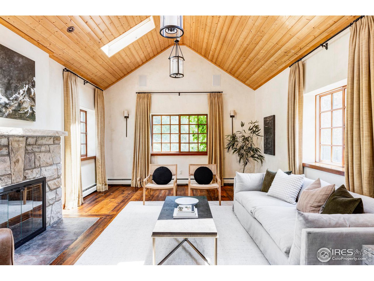 1213 17th Street Boulder, CO 80302 - Photo 14 of 38 a living room with furniture a fireplace and a floor to ceiling window