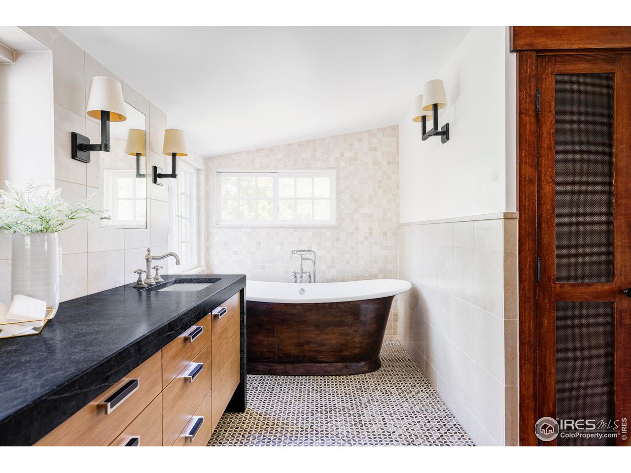1213 17th Street Boulder, CO 80302 - Photo 21 of 38 a bathroom with a sink and a mirror
