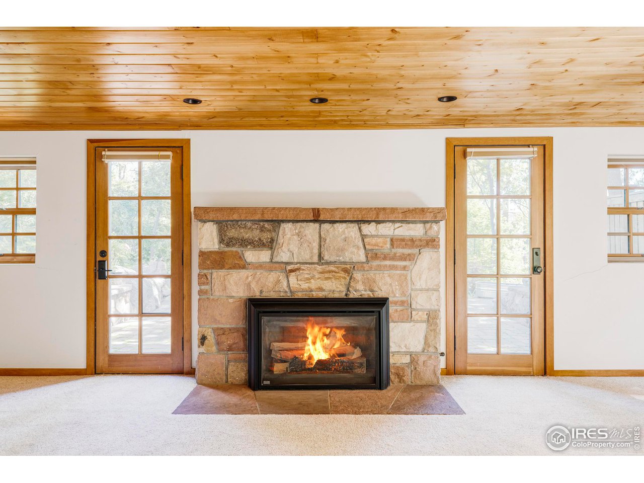 1213 17th Street Boulder, CO 80302 - Photo 26 of 38 a view of an empty room with wooden floor and a fireplace