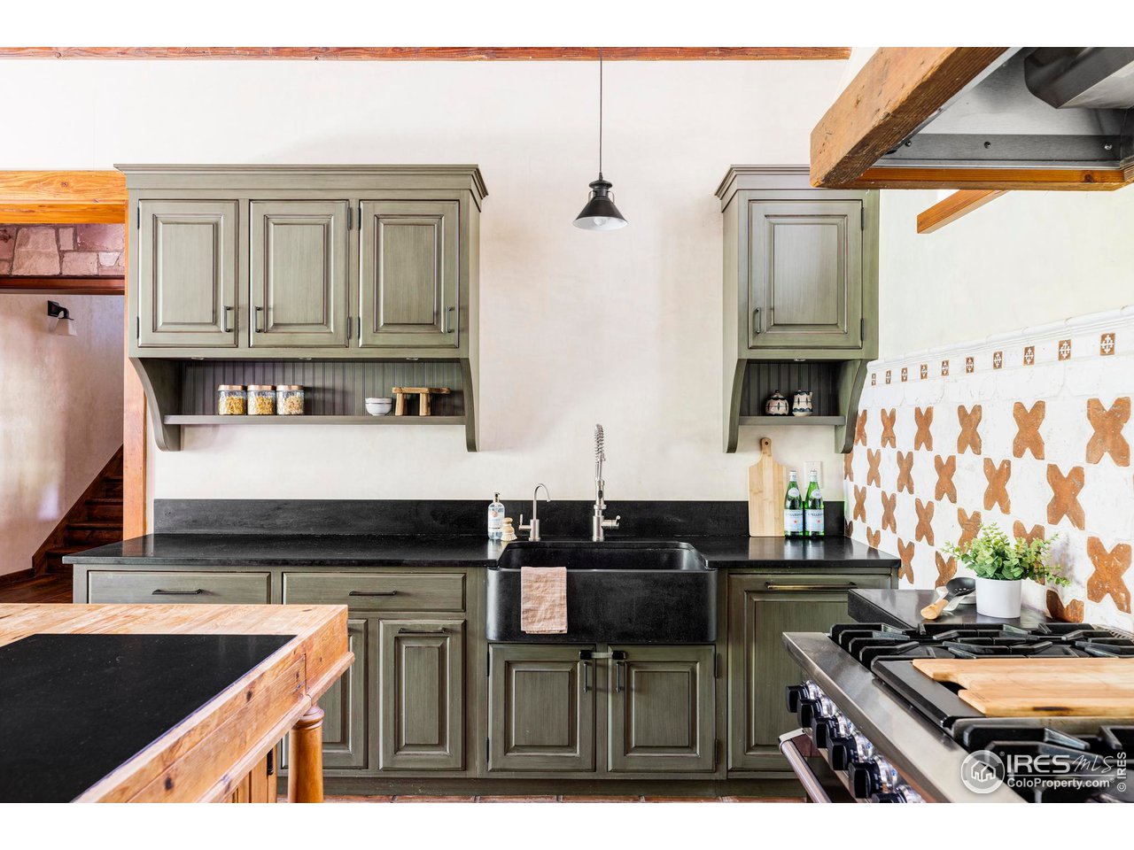1213 17th Street Boulder, CO 80302 - Photo 9 of 38 a kitchen with stainless steel appliances granite countertop a stove a sink and a microwave