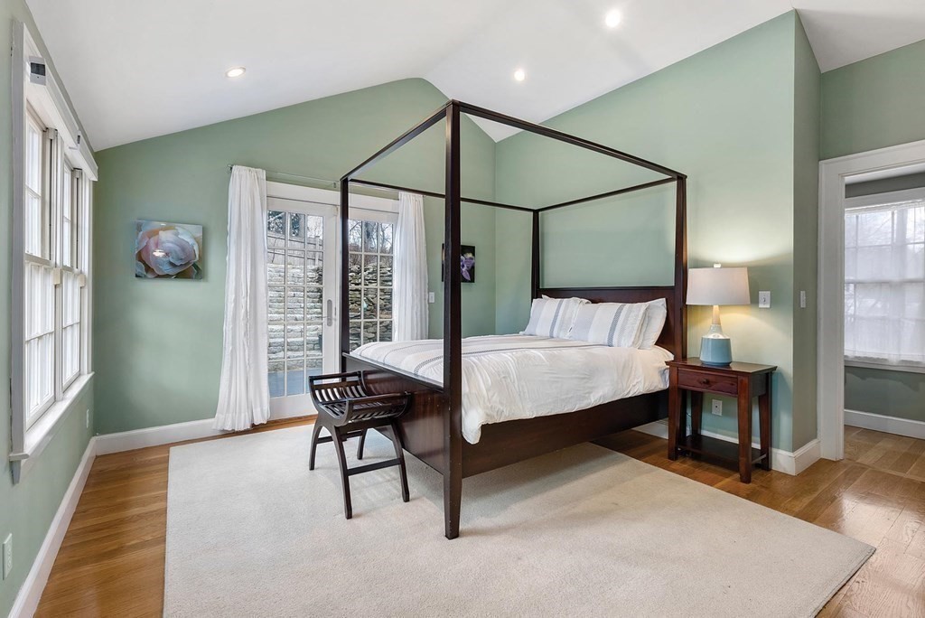 16 Conant Road Brookline, MA 02467 - Photo 22 of 31 a bedroom with a bed and a chandelier