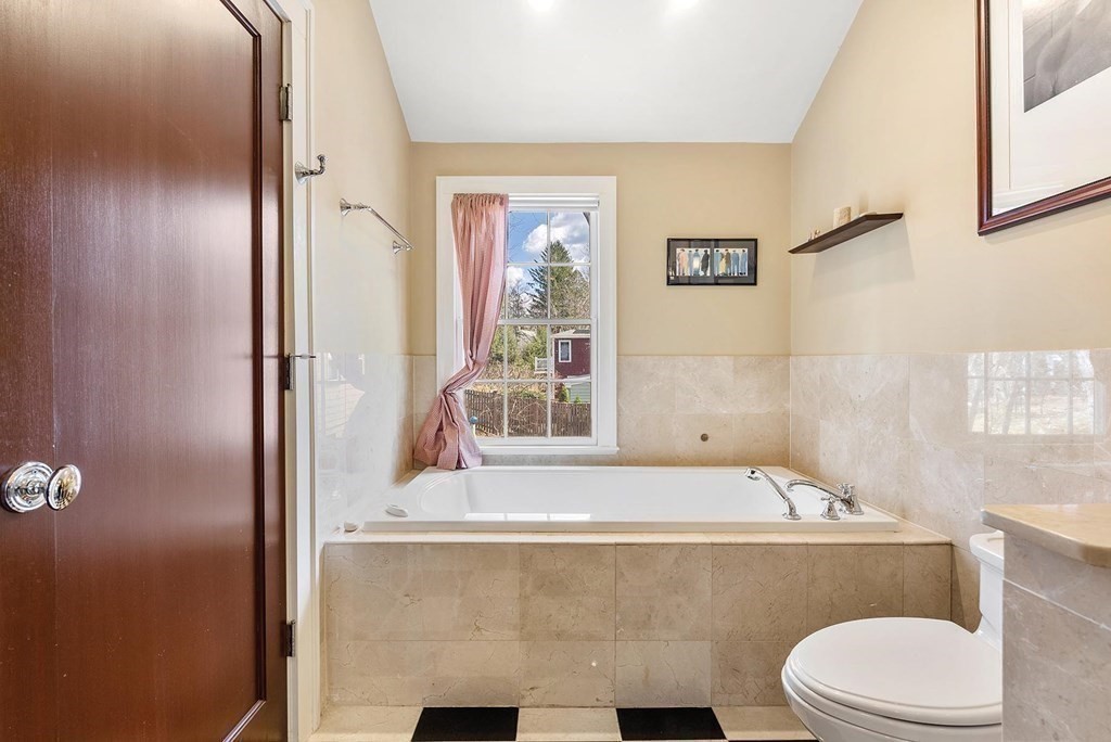 16 Conant Road Brookline, MA 02467 - Photo 27 of 31 a bathroom with a granite countertop bathtub sink vanity mirror and toilet