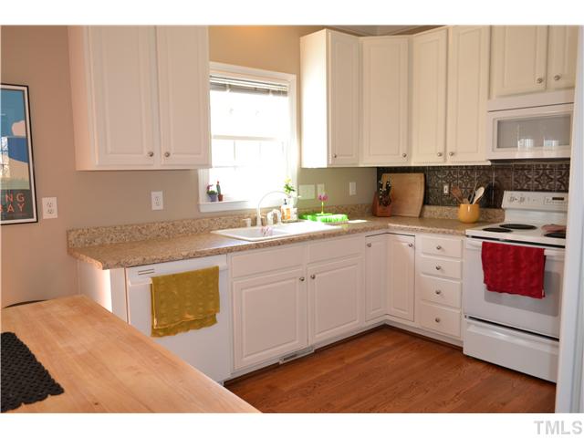 6937 Lamarsh Court Raleigh, NC 27617 - Photo 4 of 25 a kitchen with a sink dishwasher and white cabinets