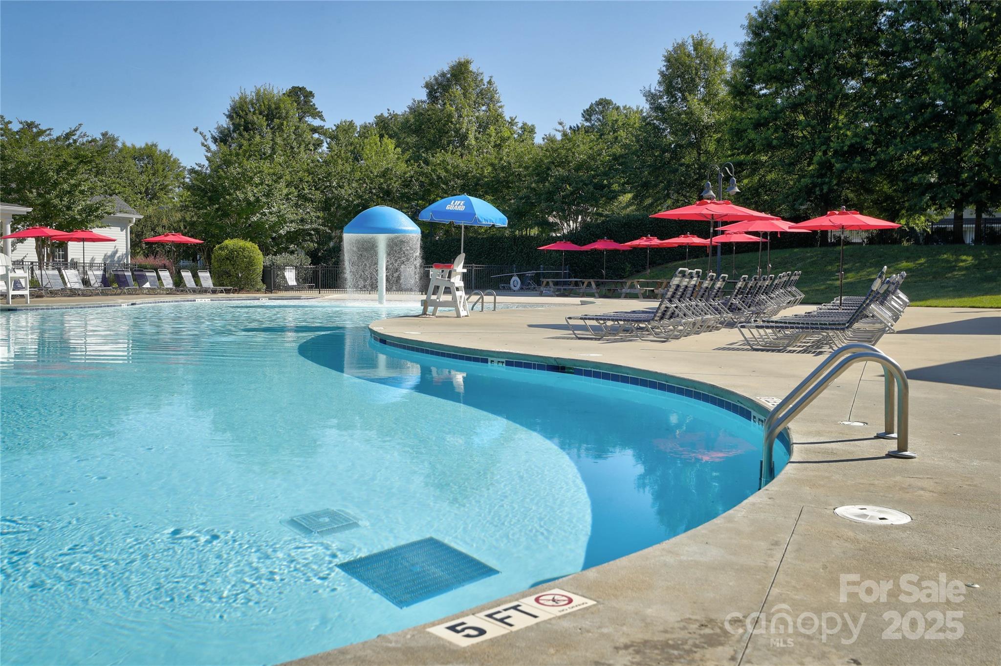296 Elis Way Fort Mill, SC 29708 - Photo 28 of 31 a view of a swimming pool with a table and chairs under an umbrella