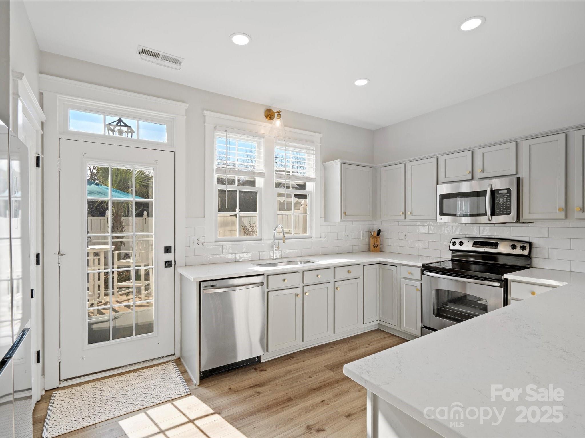 296 Elis Way Fort Mill, SC 29708 - Photo 8 of 31 a kitchen with stainless steel appliances granite countertop a stove and a sink