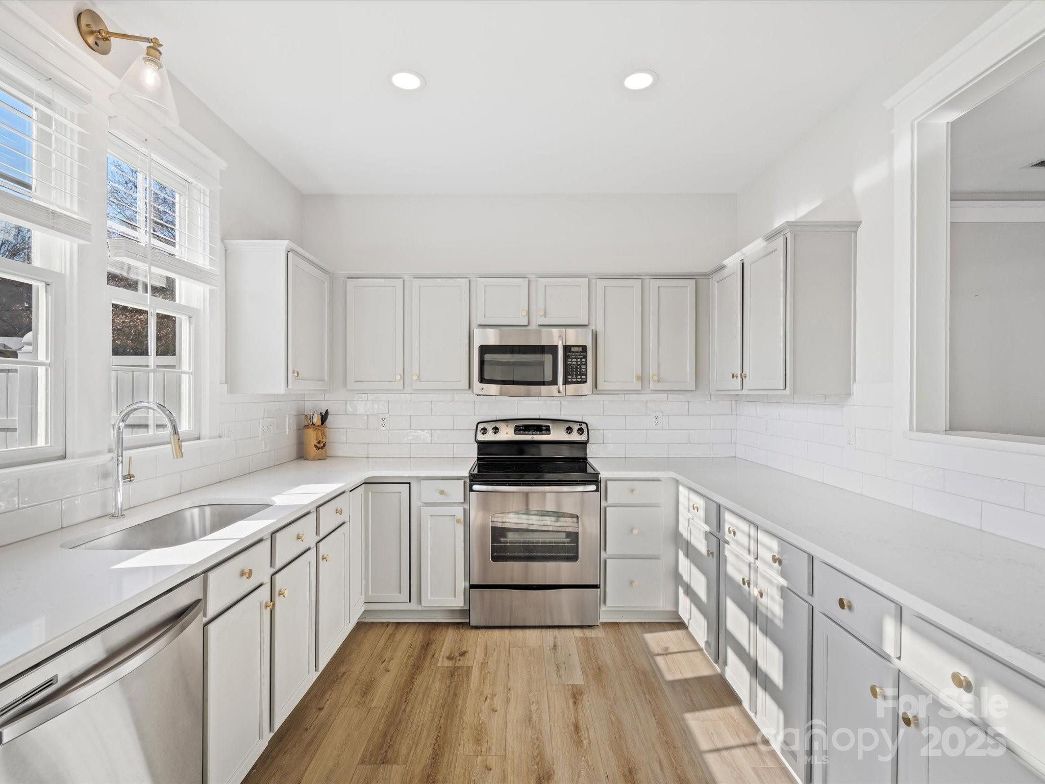 296 Elis Way Fort Mill, SC 29708 - Photo 10 of 31 a kitchen with granite countertop a sink stainless steel appliances and cabinets