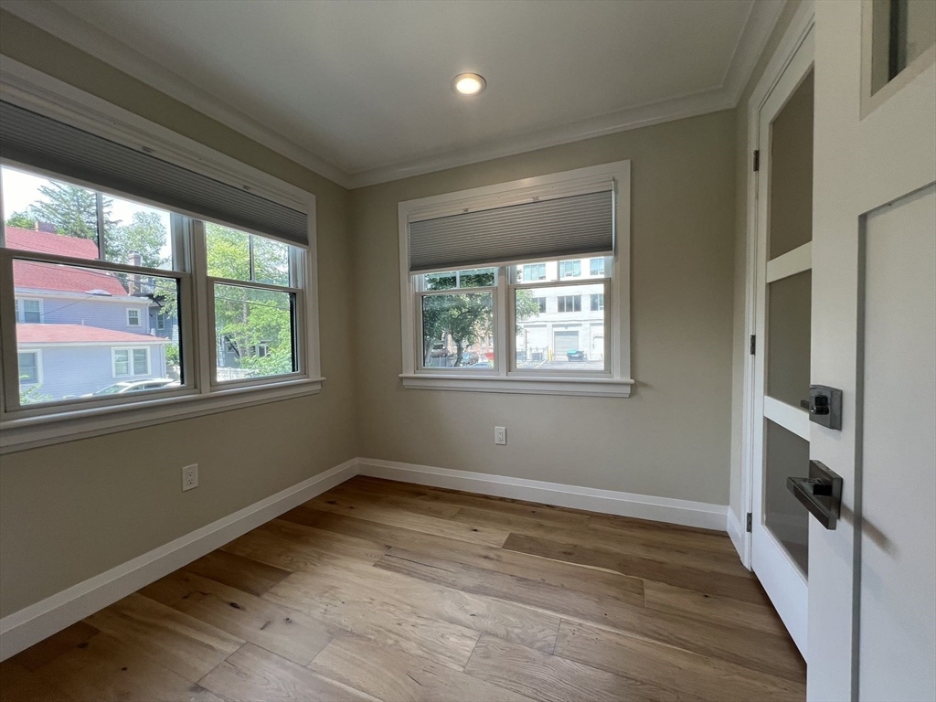 23 Winslow Road, Unit 1 Brookline, MA 02446 - Photo 15 of 27 a view of empty room with wooden floor and fan