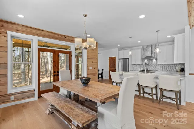 a view of a dining room with furniture wooden floor and chandelier