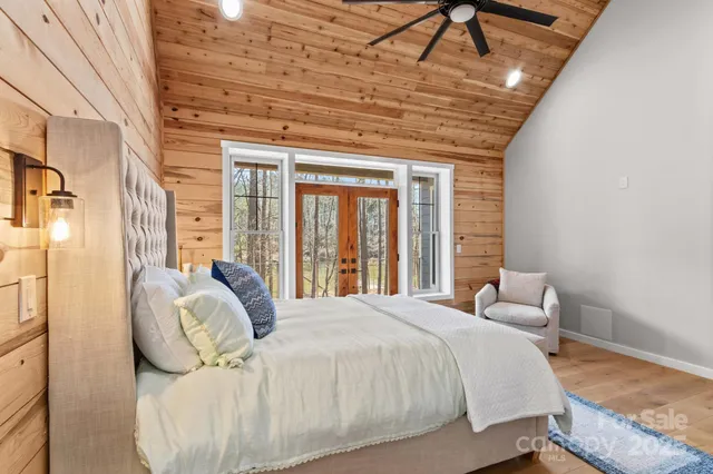 a bed sitting in a bedroom next to a window