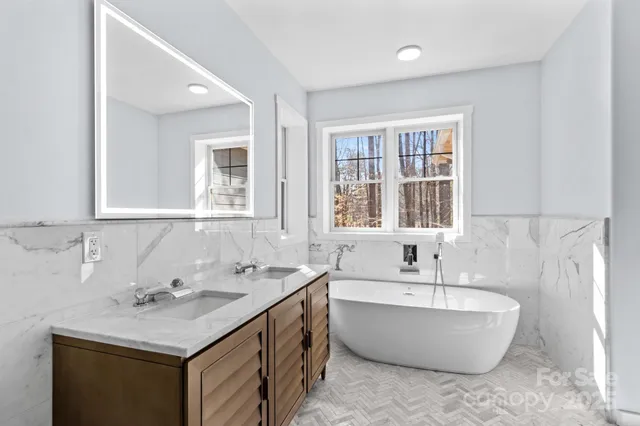 a bathroom with a bathtub a sink and a window