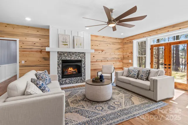 a living room with furniture a window and a fireplace